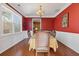 Dining room featuring wood floors, bright red paint, and white trim at 3739 Newhalem Sw St, Atlanta, GA 30331
