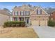 Charming two-story brick home with manicured front yard, two-car garage, and welcoming entrance at 3739 Newhalem Sw St, Atlanta, GA 30331