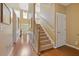 Inviting foyer featuring hardwood floors, staircase, and ample natural light at 3739 Newhalem Sw St, Atlanta, GA 30331