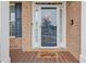 Close-up of front door with wreath, showcasing the brick facade and covered porch at 3739 Newhalem Sw St, Atlanta, GA 30331
