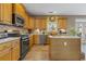 Kitchen with stainless steel appliances, tile backsplash, and island at 3739 Newhalem Sw St, Atlanta, GA 30331