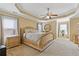 Spacious main bedroom featuring tray ceilings, a ceiling fan, and two windows at 3739 Newhalem Sw St, Atlanta, GA 30331