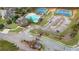 Aerial view capturing the community entrance, pool, tennis courts, playground and neighborhood landscape and access at 4681 Gablestone Dr, Hoschton, GA 30548