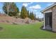 Expansive backyard features a lush lawn and landscaped hillside, perfect for outdoor enjoyment and relaxation at 4681 Gablestone Dr, Hoschton, GA 30548