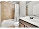 Bathroom featuring a tub and shower combo with tile surround, and a vanity with dark wood cabinets at 4681 Gablestone Dr, Hoschton, GA 30548