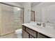 Bathroom featuring a glass enclosed shower with tile surround and a vanity with dark wood cabinets at 4681 Gablestone Dr, Hoschton, GA 30548