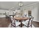Cozy dining area with a modern chandelier, large windows, and an open floorplan to kitchen at 4681 Gablestone Dr, Hoschton, GA 30548