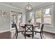 Cozy dining area with large windows, a stylish chandelier, and access to the outdoors at 4681 Gablestone Dr, Hoschton, GA 30548