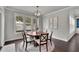 Cozy dining area with a modern chandelier, large windows, and an open floorplan at 4681 Gablestone Dr, Hoschton, GA 30548