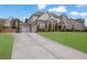 Beautifully landscaped home with long driveway and an attached two car garage at 4681 Gablestone Dr, Hoschton, GA 30548