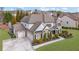Two-story home boasting a brick and siding exterior, a well-manicured lawn, three-car garage, and professional landscaping at 4681 Gablestone Dr, Hoschton, GA 30548