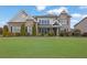 Charming brick home with a manicured lawn and beautiful landscaping at 4681 Gablestone Dr, Hoschton, GA 30548