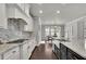 Bright kitchen featuring granite countertops, a mosaic backsplash, and modern appliances at 4681 Gablestone Dr, Hoschton, GA 30548