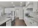 Bright kitchen featuring granite countertops, a mosaic backsplash, and modern appliances at 4681 Gablestone Dr, Hoschton, GA 30548