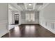 Bright living room with hardwood floors, coffered ceiling and wainscoting at 4681 Gablestone Dr, Hoschton, GA 30548