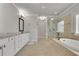 This is a main bathroom with double sinks, a soaker tub and a glass shower at 4681 Gablestone Dr, Hoschton, GA 30548