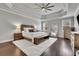 Main bedroom featuring an oversized rug, hardwood floors, and a custom ceiling at 4681 Gablestone Dr, Hoschton, GA 30548