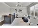 Bright home office featuring a modern light fixture, clean desk and two sitting chairs at 4681 Gablestone Dr, Hoschton, GA 30548