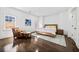 Bright bedroom featuring hardwood floors, a light rug, and a cozy seating area by the window at 5655 Cross Gate Dr, Atlanta, GA 30327