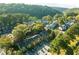 An aerial view of townhomes surrounded by lush trees and foliage next to a river at 1026 Riverbend Club Se Dr, Atlanta, GA 30339