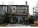 Backyard with upstairs balcony, table, chairs, and woodpile at 1026 Riverbend Club Se Dr, Atlanta, GA 30339