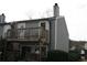 Backyard view with balcony, foliage, and woodpile at 1026 Riverbend Club Se Dr, Atlanta, GA 30339