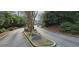 Scenic driveway winds through lush greenery, creating a private entrance to the neighborhood at 1026 Riverbend Club Se Dr, Atlanta, GA 30339