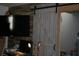 Living room with a TV and a sliding barn door to another room at 1026 Riverbend Club Se Dr, Atlanta, GA 30339