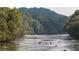 A river with people in canoes and kayaks surrounded by a luscious green forest at 1026 Riverbend Club Se Dr, Atlanta, GA 30339