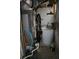 Utility room contains water heater, air conditioning unit, and various wires and plumbing at 1026 Riverbend Club Se Dr, Atlanta, GA 30339