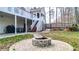 Backyard featuring a firepit, brick patio, stairs to the home and a fenced-in lawn at 1074 Fieldstone Dr, Canton, GA 30114