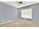 Simple bedroom features light grey walls, a ceiling fan, and bright natural light at 1074 Fieldstone Dr, Canton, GA 30114