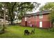 Large, shaded backyard featuring mature trees, a firepit, and partially fenced yard at 2413 Hillside Ave, Decatur, GA 30032