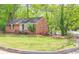 Beautiful brick home with a well-maintained lawn and a fenced-in backyard, and mature trees at 2413 Hillside Ave, Decatur, GA 30032