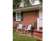 Inviting front porch with striped chairs, flowers, and a welcome sign at 2413 Hillside Ave, Decatur, GA 30032