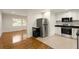 Open concept kitchen with stainless steel appliances and view into living area at 2413 Hillside Ave, Decatur, GA 30032