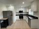 Updated kitchen featuring stainless steel appliances, granite countertops, and ample cabinet space at 2413 Hillside Ave, Decatur, GA 30032