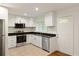 Modern kitchen features white cabinets, black countertops, and stainless steel appliances at 2413 Hillside Ave, Decatur, GA 30032