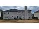 Spacious backyard featuring a well-maintained lawn, patio area, and the home's exterior at 2453 Wall Se St, Conyers, GA 30013