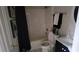 Well-lit bathroom with a toilet, bathtub, shower, and black curtains, creating a comfortable and functional space at 2453 Wall Se St, Conyers, GA 30013