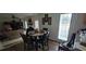 Inviting dining area with a round table, modern chairs, and an adjacent living room at 2453 Wall Se St, Conyers, GA 30013