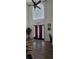 Inviting front entryway with high ceilings, a decorative front door, hardwood floors, and bright natural lighting at 2453 Wall Se St, Conyers, GA 30013