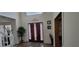 Inviting entryway with a decorative front door, hardwood floors, bright lighting, and a view into the rest of the home at 2453 Wall Se St, Conyers, GA 30013