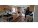 Efficient kitchen featuring wooden cabinets, stainless steel appliances, and durable flooring with backyard view at 2453 Wall Se St, Conyers, GA 30013