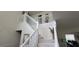 Carpeted staircase with white wood banisters in a home with neutral colored walls, a high ceiling, and decorative artwork at 2453 Wall Se St, Conyers, GA 30013