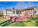 View of the backyard patio with brick retaining wall and sunroom addition, with a brick house at 2826 Summit Ridge Dr, Marietta, GA 30066