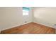 Bright bedroom with hardwood floors, light walls, and a window with a blue curtain at 2826 Summit Ridge Dr, Marietta, GA 30066