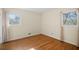 Bedroom featuring hardwood floors, two windows, and neutral wall color at 2826 Summit Ridge Dr, Marietta, GA 30066