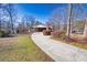 Spacious driveway leading to a charming single-story home with a covered carport and established landscaping at 2826 Summit Ridge Dr, Marietta, GA 30066