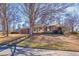 View of the exterior of the home and front yard, which features mature trees, a manicured lawn, and brick architecture at 2826 Summit Ridge Dr, Marietta, GA 30066